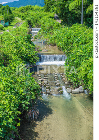 The clear stream of Tenjin River flowing through Ogi, Otsu City, Shiga Prefecture. The clear stream of Tenjin River flowing through Ogi, Otsu City, Shiga Prefecture. 141154861