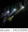 The colorful spotlight beams of light from the stage pierce through the smoke, square-shaped 141155040