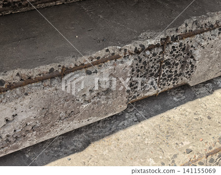 Damaged concrete slab with exposed rusty rebar reinforcement close up Damaged concrete slab with exposed rusty rebar reinforcement close up 141155069
