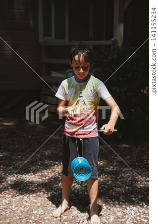 Boy Playing Diabolo Outdoors Boy Playing Diabolo Outdoors 141155234