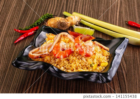 Seafood fried rice with shrimp and squid in black bowl Seafood fried rice with shrimp and squid in black bowl 141155438