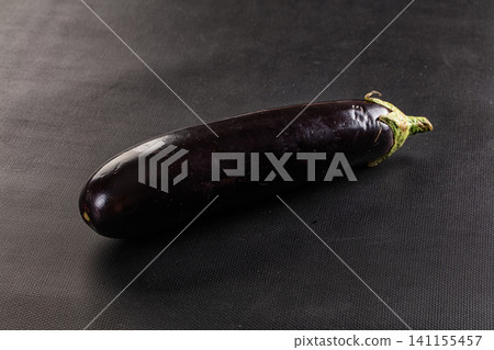 Single eggplant on dark textured background Single eggplant on dark textured background 141155457