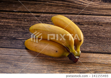 Fresh yellow bananas on rustic wooden table 141155493