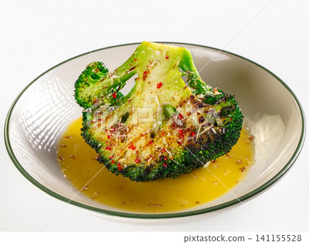 Roasted broccoli with cheese and chili flakes in ceramic bowl Roasted broccoli with cheese and chili flakes in ceramic bowl 141155528