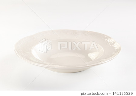 Elegant white ceramic bowl with embossed floral rim on minimalist background Elegant white ceramic bowl with embossed floral rim on minimalist background 141155529