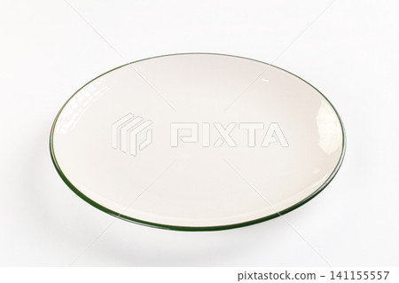 White ceramic plate with dark green rim on white background White ceramic plate with dark green rim on white background 141155557