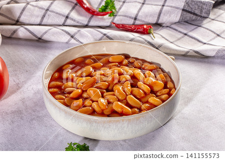Baked beans in a ceramic bowl with tomato sauce and chili peppers Baked beans in a ceramic bowl with tomato sauce and chili peppers 141155573