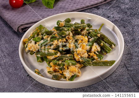 Stir Fried Green Beans with Scrambled Eggs on White Plate 141155651