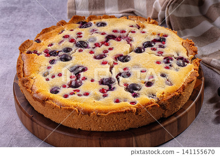 Blueberry and red currant pie on wooden board with checkered cloth Blueberry and red currant pie on wooden board with checkered cloth 141155670