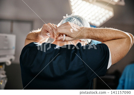 Healthcare, cap and doctor in theatre for safety, cardiovascular surgery and protection in hospital. Emergency, surgeon and man with getting ready for operation, preparation or medical procedure Healthcare, cap and doctor in theatre for safety, cardiovascular surgery and protection in hospital. Emergency, surgeon and man with getting ready for operation, preparation or medical procedure 141157090