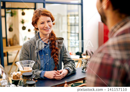 Woman, customer and waiter at counter in cafe for order, decision and talking for drink in morning. Girl, barista and catering service at trendy coffee shop for cappuccino, latte or espresso in Italy Woman, customer and waiter at counter in cafe for order, decision and talking for drink in morning. Girl, barista and catering service at trendy coffee shop for cappuccino, latte or espresso in Italy 141157110
