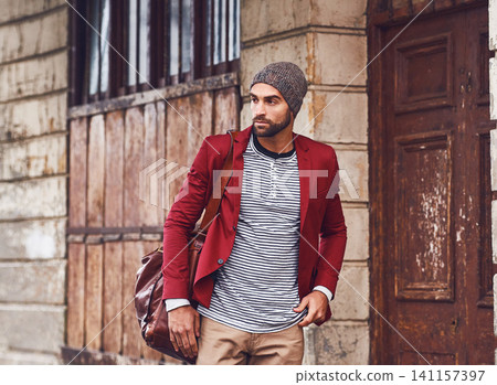 Fashion, walking and man in city for travel on sightseeing vacation, adventure or holiday. Retro, bag and male person with cool, trendy and winter style for outfit in urban town for weekend trip. Fashion, walking and man in city for travel on sightseeing vacation, adventure or holiday. Retro, bag and male person with cool, trendy and winter style for outfit in urban town for weekend trip. 141157397