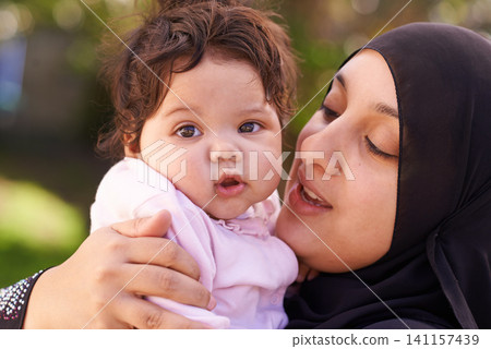 Muslim woman, mother and baby with hug for love, care and bonding during Eid in Cape Town, South Africa. Female person, child and family together outdoor in nature, garden and backyard with affection Muslim woman, mother and baby with hug for love, care and bonding during Eid in Cape Town, South Africa. Female person, child and family together outdoor in nature, garden and backyard with affection 141157439