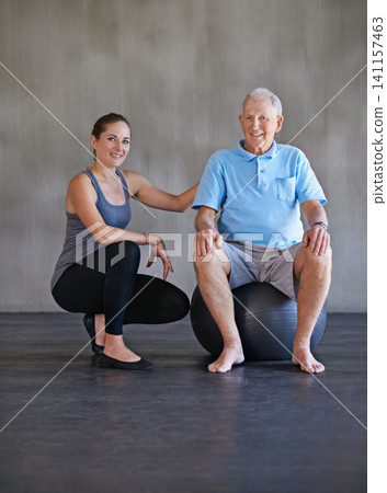 Exercise ball, smile and physiotherapist with patient for muscle exercise consultation at clinic. Physical therapy, happy and portrait of healthcare worker helping senior man at rehabilitation center Exercise ball, smile and physiotherapist with patient for muscle exercise consultation at clinic. Physical therapy, happy and portrait of healthcare worker helping senior man at rehabilitation center 141157463
