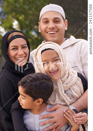 Family, smile and portrait for bonding, childhood and happiness in backyard for parents, kids and ramadan. Muslim people or mother and father with children in religious clothes for islam and eid Family, smile and portrait for bonding, childhood and happiness in backyard for parents, kids and ramadan. Muslim people or mother and father with children in religious clothes for islam and eid 141157508