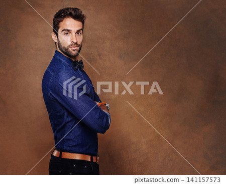 Fashion, portrait and business man in studio with arms crossed for confidence, serious or corporate on brown background. Entrepreneur, consultant and male person for formal, styling or trendy clothes 141157573