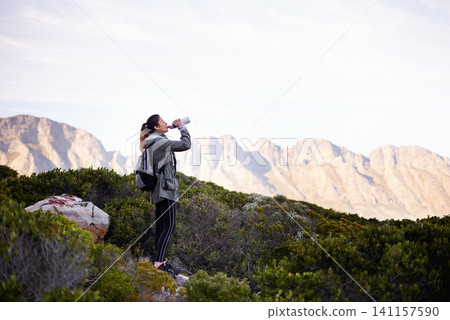 Woman, hiking and mountain or drinking water for exercise break for trekking adventure, wellness or fitness. Female person, journey and outdoor view for environment workout or travel, holiday or trip Woman, hiking and mountain or drinking water for exercise break for trekking adventure, wellness or fitness. Female person, journey and outdoor view for environment workout or travel, holiday or trip 141157590