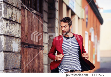 Man, think and fashion in urban outdoor with outfit for casual or smart wear on wall for trends and style. Confident, street and city in elegant clothes with blazer in downtown for classy look Man, think and fashion in urban outdoor with outfit for casual or smart wear on wall for trends and style. Confident, street and city in elegant clothes with blazer in downtown for classy look 141157700