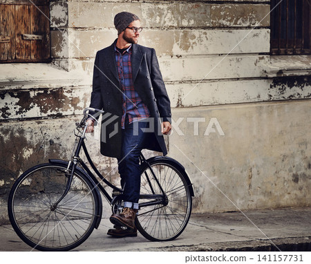 Bike, fashion and man in city for travel on winter vacation, adventure or holiday with retro style. Vintage, stylish and male person on bicycle for cycling with beanie and coat for outfit in town. 141157731