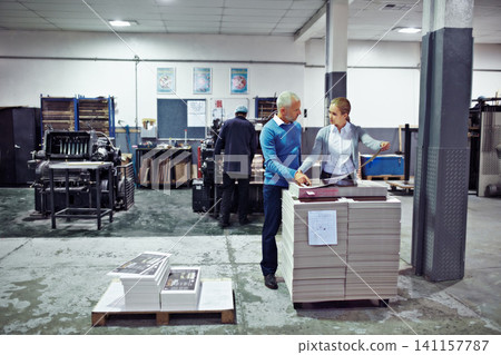Printing, factory and people with paper for inspection, collaboration and quality control with paper. Warehouse, teamwork and man and woman for logistics, manufacturing and industrial production Printing, factory and people with paper for inspection, collaboration and quality control with paper. Warehouse, teamwork and man and woman for logistics, manufacturing and industrial production 141157787