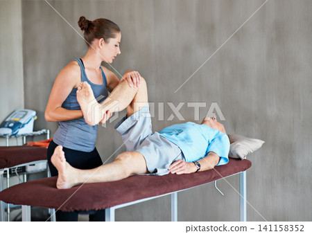 Physiotherapist, legs and elderly man with physical therapy exercise at rehabilitation center. Medical, help and therapist with senior male patient with consultation for muscle injury at clinic. Physiotherapist, legs and elderly man with physical therapy exercise at rehabilitation center. Medical, help and therapist with senior male patient with consultation for muscle injury at clinic. 141158352