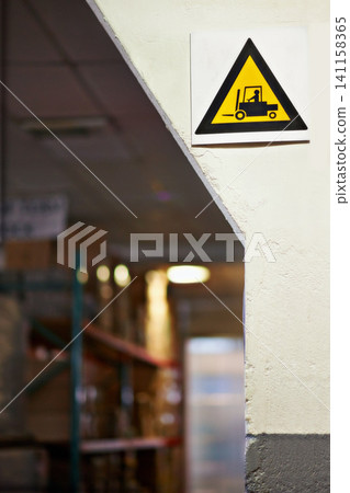 Warning, sign and forklift with triangle or symbol for alert, precaution or safety at warehouse or factory. Empty room with hazard billboard for beware of vehicle, lifting or transport at manufacture Warning, sign and forklift with triangle or symbol for alert, precaution or safety at warehouse or factory. Empty room with hazard billboard for beware of vehicle, lifting or transport at manufacture 141158365