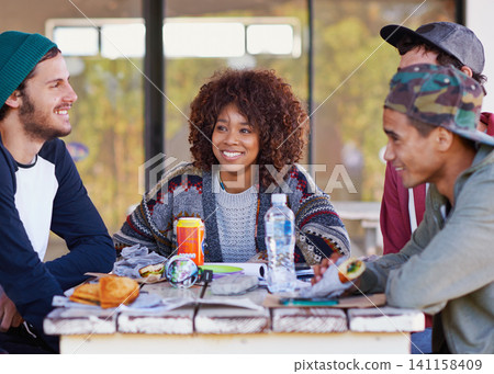 Friends, group and outdoor table for eating lunch together on backyard patio for bonding, relaxing or connection. Men, women and smile with beverages for community gathering, communication or snack Friends, group and outdoor table for eating lunch together on backyard patio for bonding, relaxing or connection. Men, women and smile with beverages for community gathering, communication or snack 141158409