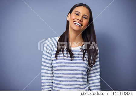Woman, happy and laugh in studio portrait for funny joke, humor and comedy on blue background. Female person, mockup space and smile for comic satisfaction, confidence and silly or goofy enjoyment 141158485