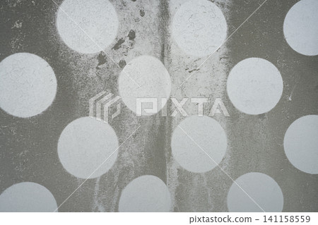 The image features a textured gray background with a pattern of large, irregularly placed white circles. The image features a textured gray background with a pattern of large, irregularly placed white circles. 141158559
