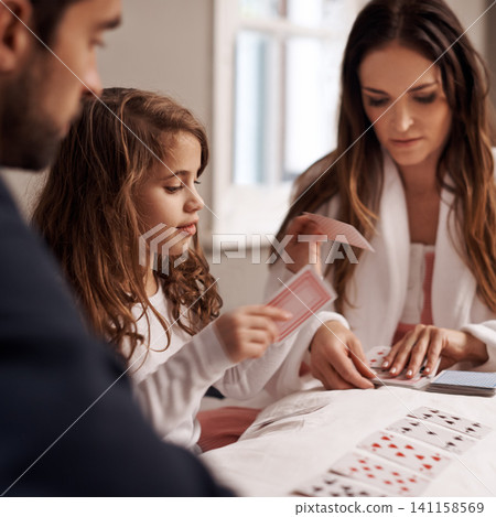 Mom, father and girl with playing cards in home with bonding, learning and relax with strategy in bedroom. Dad, mother and daughter with deal, game and teaching on bed with connection in family house Mom, father and girl with playing cards in home with bonding, learning and relax with strategy in bedroom. Dad, mother and daughter with deal, game and teaching on bed with connection in family house 141158569