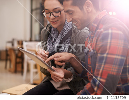 Happy people, students and discussion with tablet at cafe on project at indoor restaurant. Man, woman or friends with smile on technology for online browsing, research or communication at coffee shop Happy people, students and discussion with tablet at cafe on project at indoor restaurant. Man, woman or friends with smile on technology for online browsing, research or communication at coffee shop 141158709