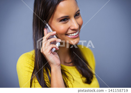 Woman, phone call and smile in studio with talk for conversation, contact or listen by blue background. Girl, person and model on smartphone, happy and thinking with idea on mobile network in Mexico 141158719