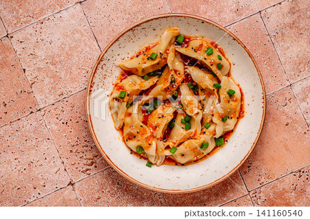 Dumplings with spicy sauce served on a plate Dumplings with spicy sauce served on a plate 141160540