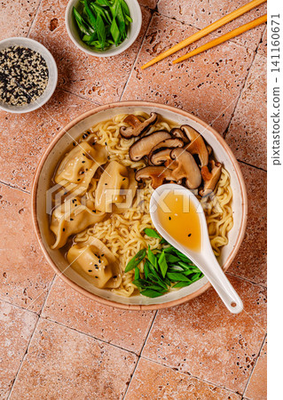Delicious bowl of noodles with dumplings and mushrooms Delicious bowl of noodles with dumplings and mushrooms 141160671