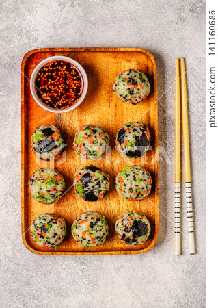 Korean rice balls (jumeokbap) with vegetables served with sauce Korean rice balls (jumeokbap) with vegetables served with sauce 141160686