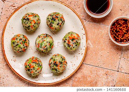 Korean rice balls (jumeokbap) with vegetables served with sauce Korean rice balls (jumeokbap) with vegetables served with sauce 141160688