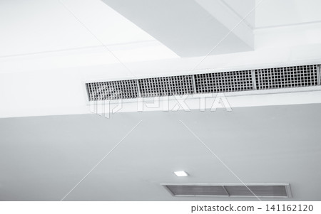 Air flow and ventilation system. Air Handling Units on ceiling walls for efficient cooling. Building ventilation. Air Handling Units and climate control systems. Ceiling-mounted ventilation units. Air flow and ventilation system. Air Handling Units on ceiling walls for efficient cooling. Building ventilation. Air Handling Units and climate control systems. Ceiling-mounted ventilation units. 141162120