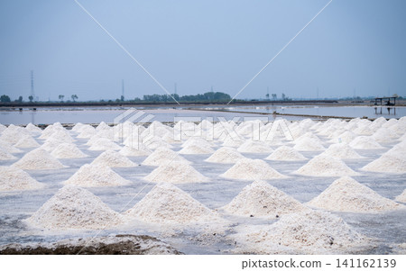 Landscape sea salt farm in Thailand. Brine salt. Raw material of salt industrial. Sodium Chloride. Evaporation and crystallization of sea water. Salt harvesting. Agriculture industry. Traditional farm Landscape sea salt farm in Thailand. Brine salt. Raw material of salt industrial. Sodium Chloride. Evaporation and crystallization of sea water. Salt harvesting. Agriculture industry. Traditional farm 141162139