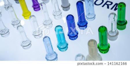 PET plastic bottle preforms before blow molding. Packaging industry. PET preforms from preforms injection molding machine. Raw material for PET bottle. Recycle plastic. Polyethylene terephthalate. PET plastic bottle preforms before blow molding. Packaging industry. PET preforms from preforms injection molding machine. Raw material for PET bottle. Recycle plastic. Polyethylene terephthalate. 141162166