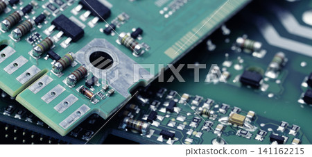 Close-up of a printed circuit board or PCB featuring wiring and microchip components. Advanced technology, precision engineering, and electronic hardware for modern devices and systems. PCB design. Close-up of a printed circuit board or PCB featuring wiring and microchip components. Advanced technology, precision engineering, and electronic hardware for modern devices and systems. PCB design. 141162215