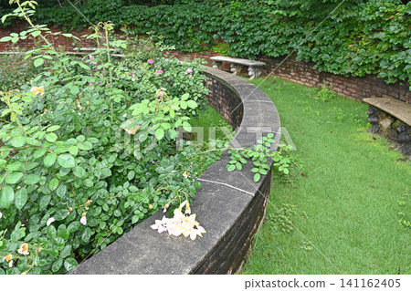 A circular brick flowerbed and benches: A lush, hidden garden in Nanatsudo Park, Mito City. A circular brick flowerbed and benches: A lush, hidden garden in Nanatsudo Park, Mito City. 141162405