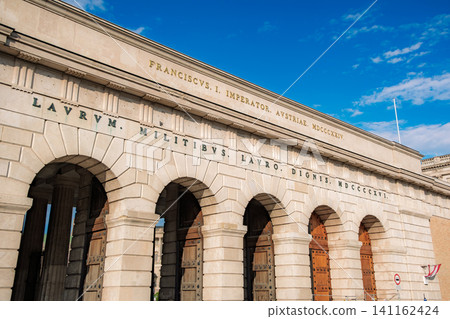 Vienna, Austria: The imposing stone gate (Burgtor) of the Hofburg Palace stands tall against the blue sky. Vienna, Austria: The imposing stone gate (Burgtor) of the Hofburg Palace stands tall against the blue sky. 141162424