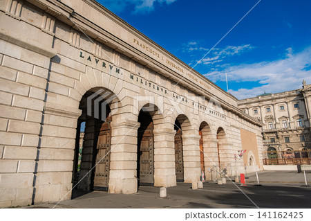 Vienna, Austria: The imposing stone gate (Burgtor) of the Hofburg Palace stands tall against the blue sky. Vienna, Austria: The imposing stone gate (Burgtor) of the Hofburg Palace stands tall against the blue sky. 141162425