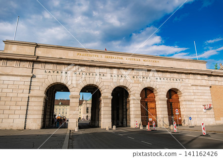 Vienna, Austria: The imposing stone gate (Burgtor) of the Hofburg Palace stands tall against the blue sky. Vienna, Austria: The imposing stone gate (Burgtor) of the Hofburg Palace stands tall against the blue sky. 141162426