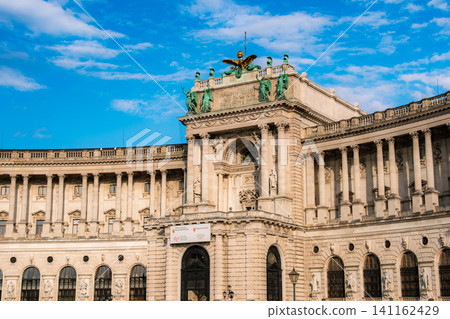 The magnificent central facade and beautifully decorated architecture of the Hofburg Palace (New Palace) in Vienna, Austria. The magnificent central facade and beautifully decorated architecture of the Hofburg Palace (New Palace) in Vienna, Austria. 141162429