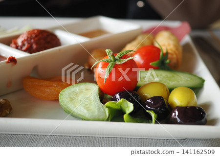 Fresh veggies and fruits on a healthy lunch plate Fresh veggies and fruits on a healthy lunch plate 141162509