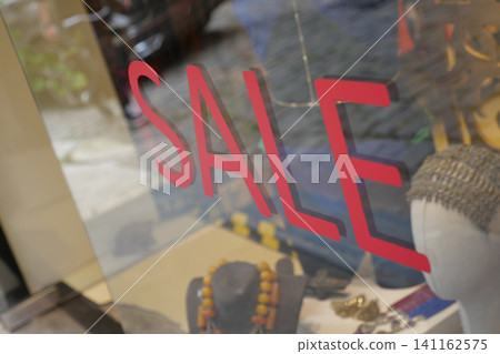 Jewelry sale sign seen through a shop window in town Jewelry sale sign seen through a shop window in town 141162575