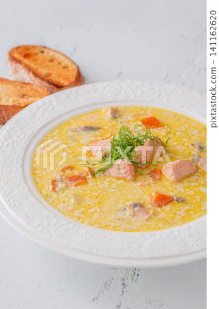 Finnish creamy salmon soup lohikeitto with vegetables served in elegant white plate Finnish creamy salmon soup lohikeitto with vegetables served in elegant white plate 141162620