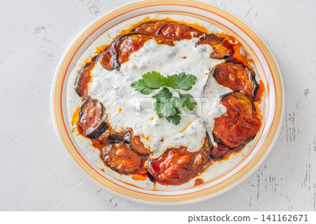 Burani Bonjan Afghan eggplant dish with yogurt garlic sauce and parsley garnish Burani Bonjan Afghan eggplant dish with yogurt garlic sauce and parsley garnish 141162671