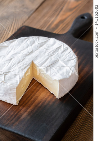 Creamy Camembert Cheese Wheel With Slice Removed On Rustic Wooden Board Display 141162682